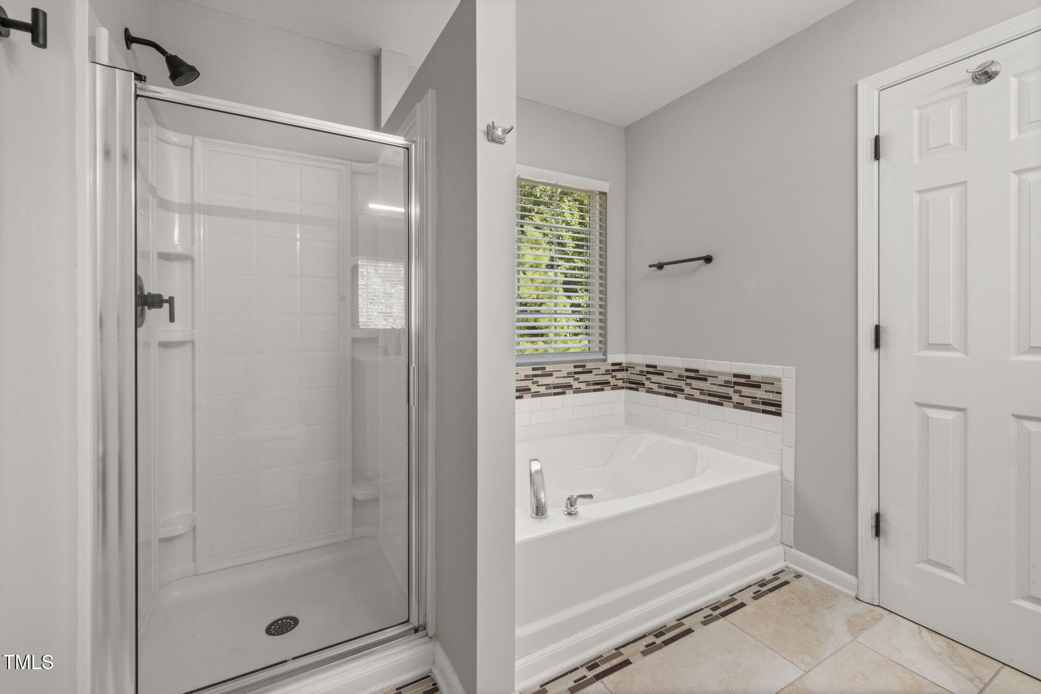 2701 Skybrook Lane Durham, NC 27703 - Photo 16 of 24 a bathroom with a bathtub and shower