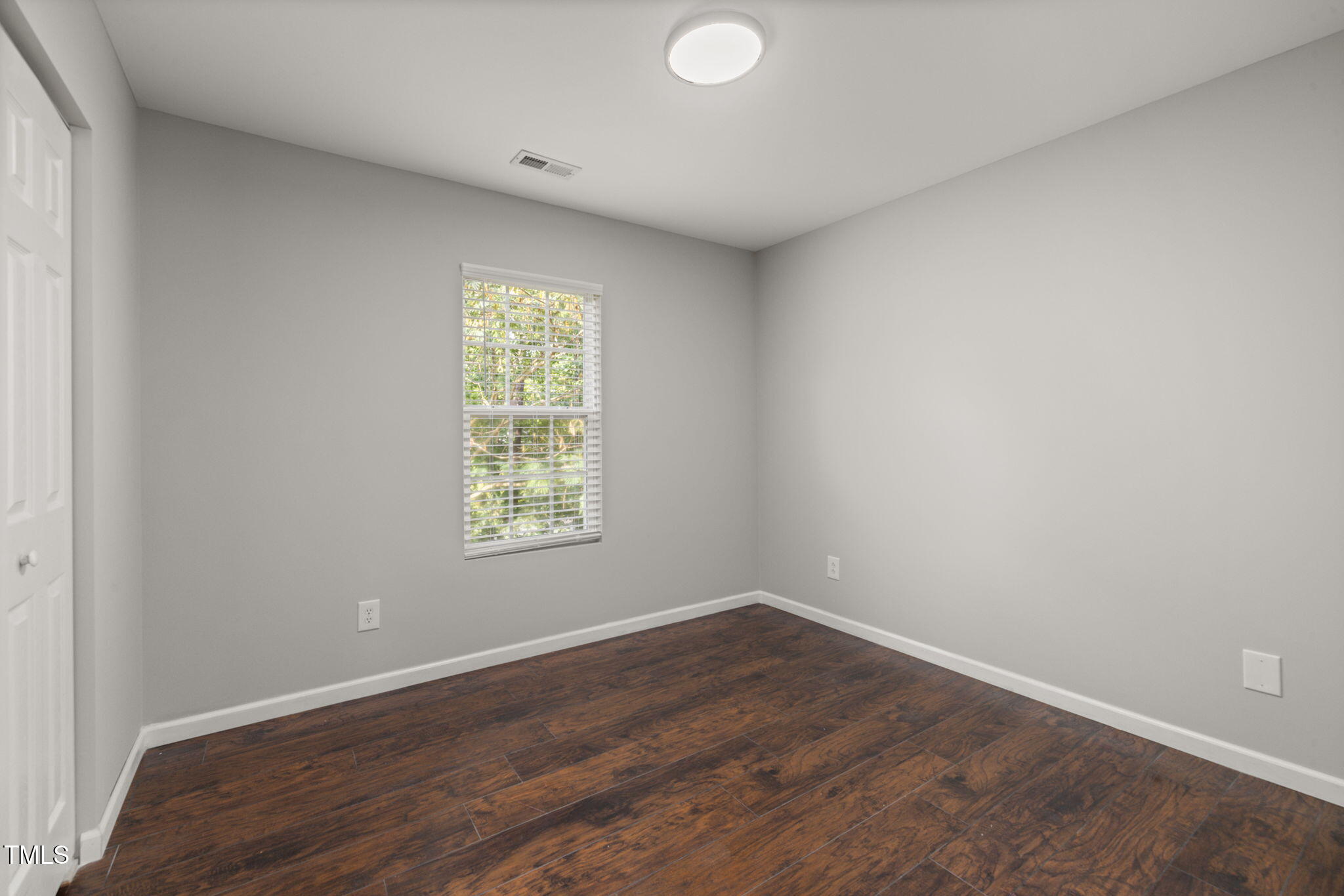 2701 Skybrook Lane Durham, NC 27703 - Photo 18 of 24 an empty room with wooden floor and windows