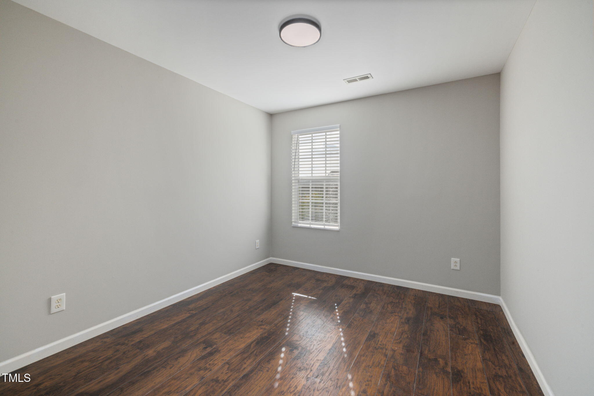 2701 Skybrook Lane Durham, NC 27703 - Photo 19 of 24 an empty room with wooden floor and windows