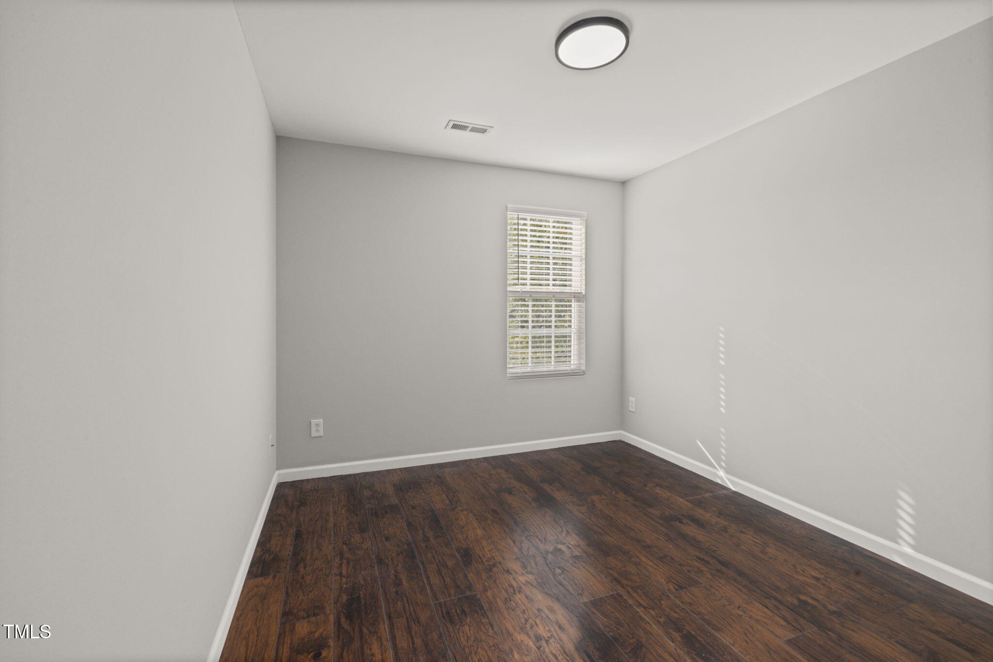 2701 Skybrook Lane Durham, NC 27703 - Photo 20 of 24 an empty room with wooden floor and windows