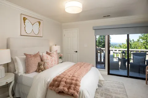 a bedroom with a large bed and a large window