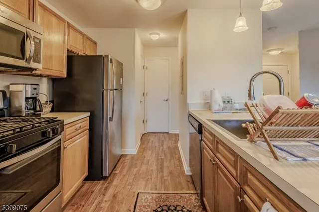 a kitchen with stainless steel appliances granite countertop a stove and a refrigerator