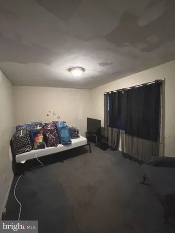 a view of a room with furniture and a fan