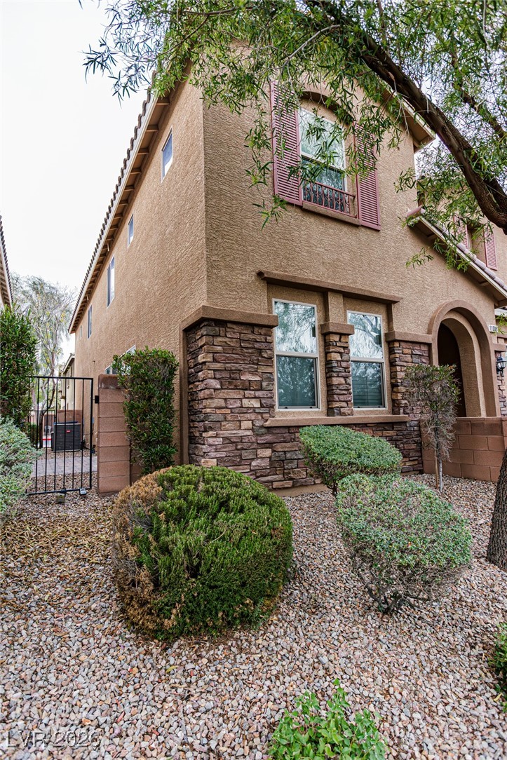 11009 Ketchikan Street Las Vegas, NV 89179 - Photo 3 of 59 View of home's exterior with stucco siding, a gate, and stone siding