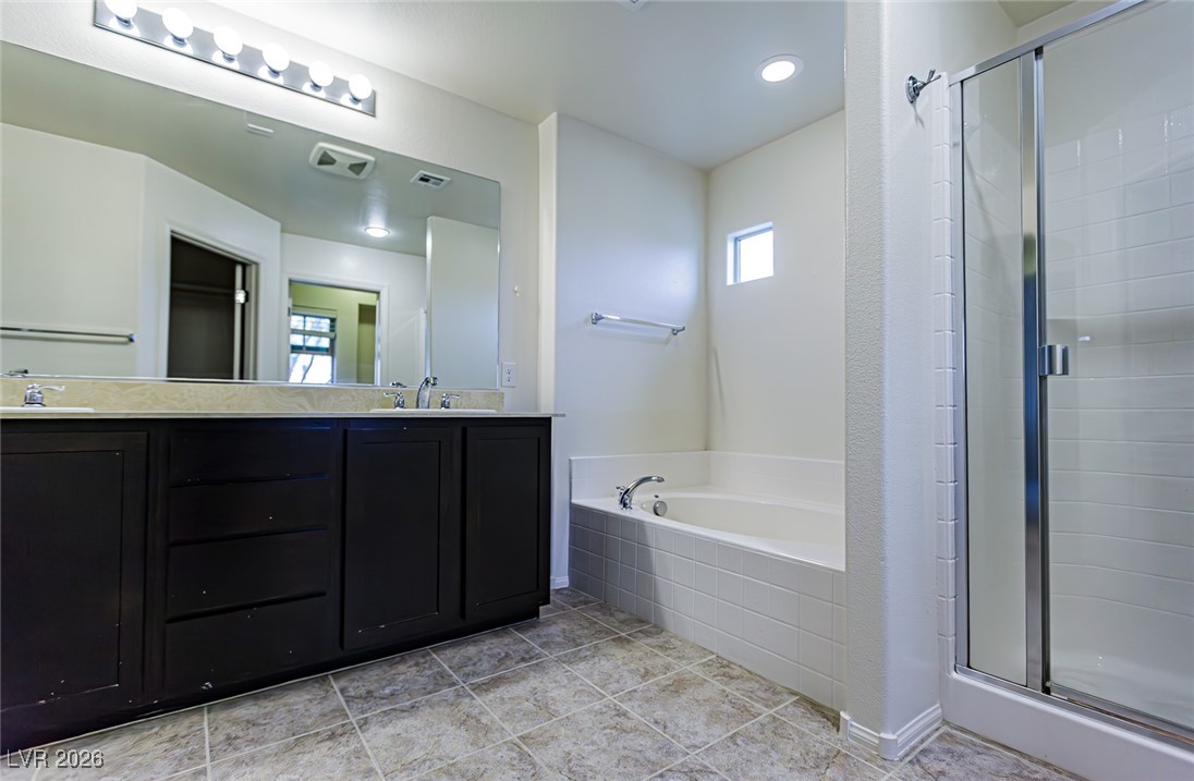 11009 Ketchikan Street Las Vegas, NV 89179 - Photo 49 of 59 Bathroom with a stall shower, double vanity, a bath, and light tile patterned flooring