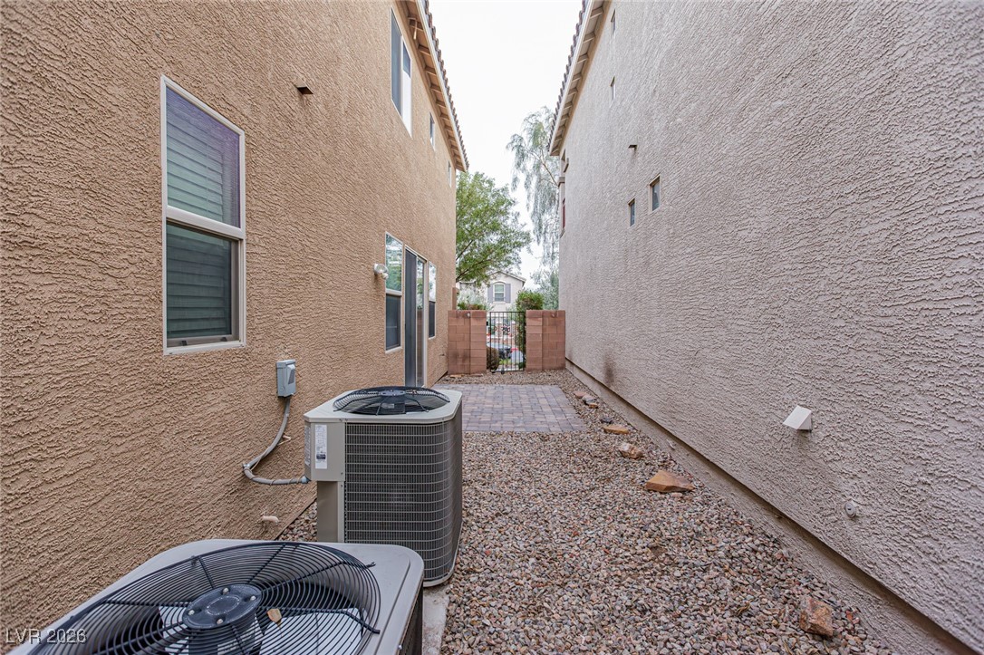 11009 Ketchikan Street Las Vegas, NV 89179 - Photo 52 of 59 View of side of property featuring stucco siding and a patio area