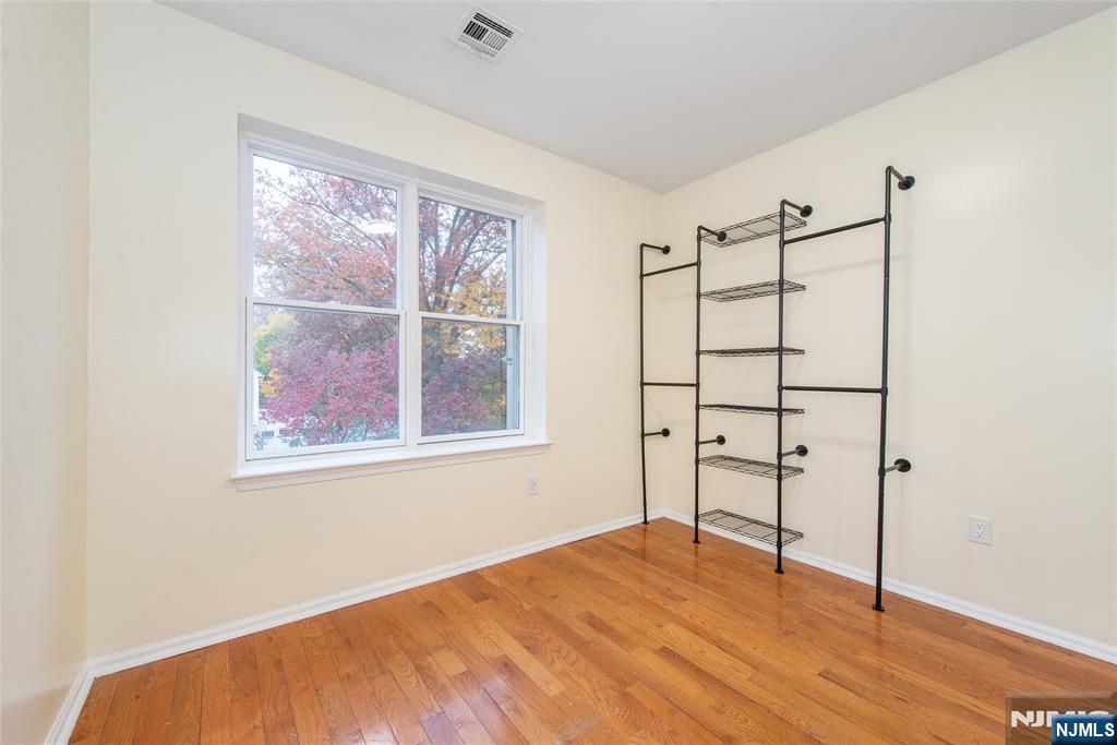 1878 Springfield Avenue, Unit 2B Maplewood, NJ 07040 - Photo 14 of 15 a view of empty room with wooden floor and fan