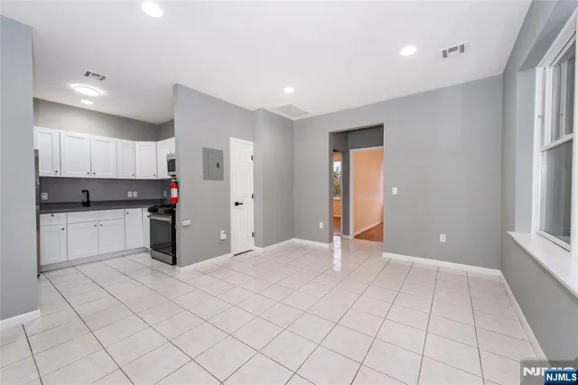 a view of a kitchen with white cabinets