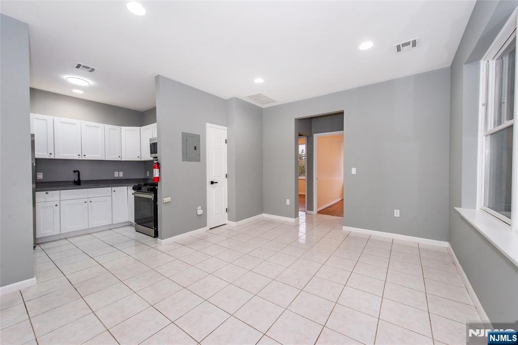 1878 Springfield Avenue, Unit 2B Maplewood, NJ 07040 - Photo 5 of 15 a view of a kitchen with white cabinets