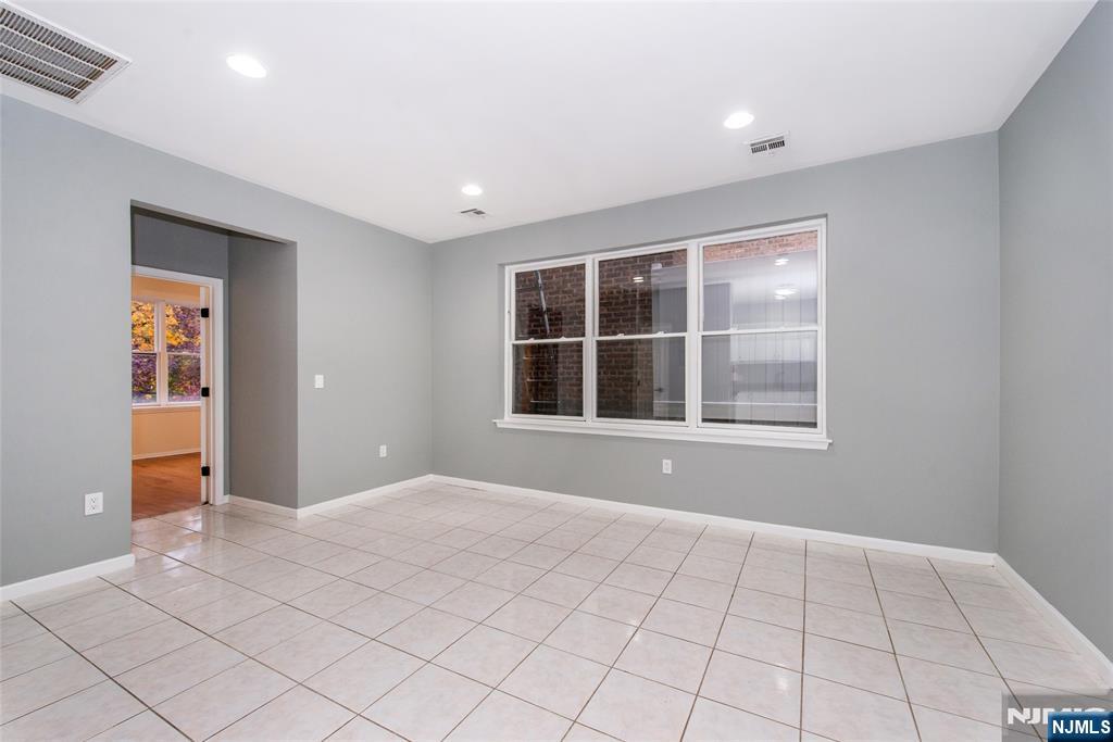 1878 Springfield Avenue, Unit 2B Maplewood, NJ 07040 - Photo 9 of 15 a view of an empty room with window and cabinet