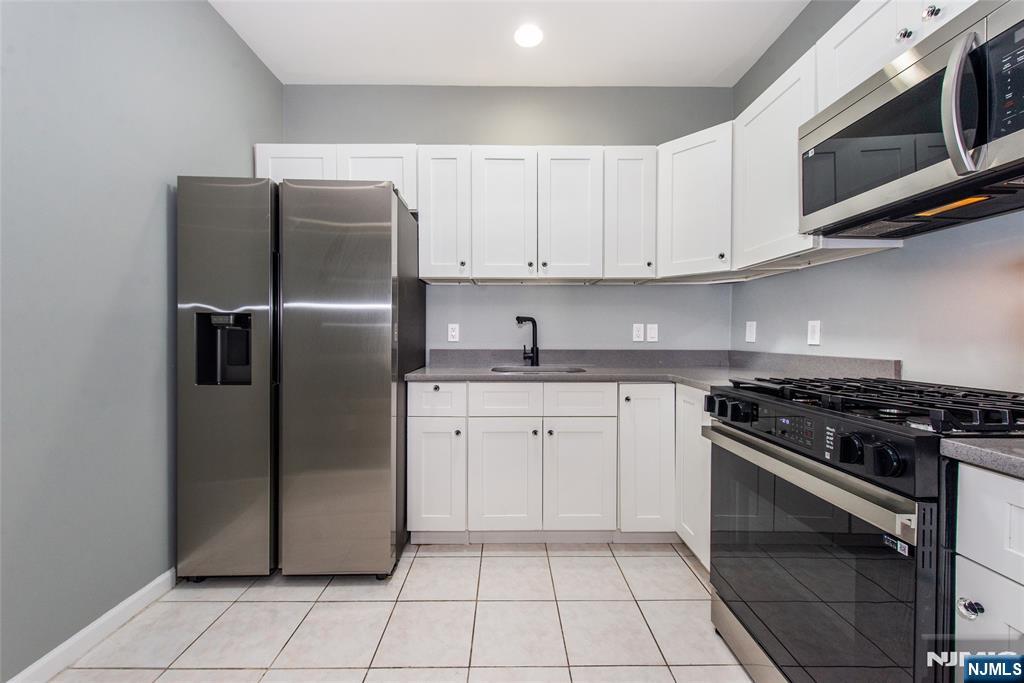 1878 Springfield Avenue, Unit 2B Maplewood, NJ 07040 - Photo 10 of 15 a kitchen with a refrigerator stove and microwave