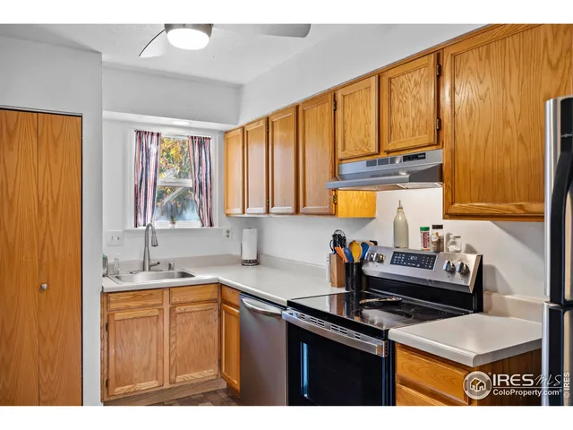 a kitchen with a sink a counter top space and cabinets