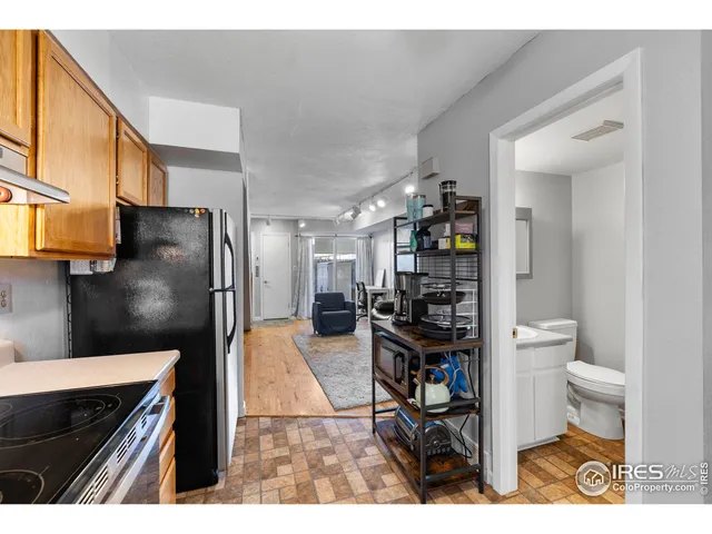 a kitchen view with stainless steel appliances a refrigerator and a stove top oven