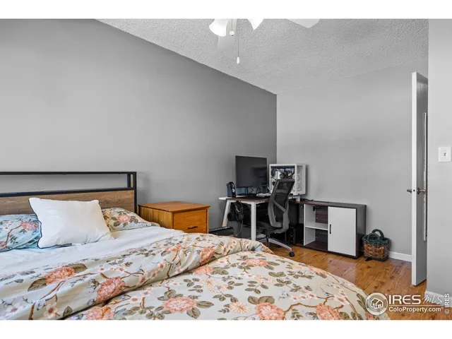 a bedroom with a bed and a television