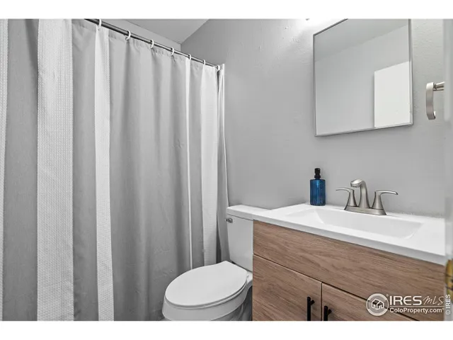 a bathroom with a sink a toilet and mirror
