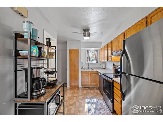 a kitchen with stainless steel appliances granite countertop a refrigerator and a stove