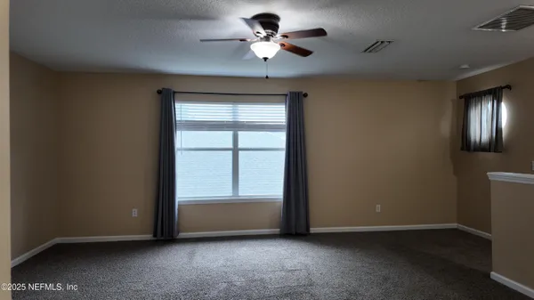 a view of room with ceiling fan