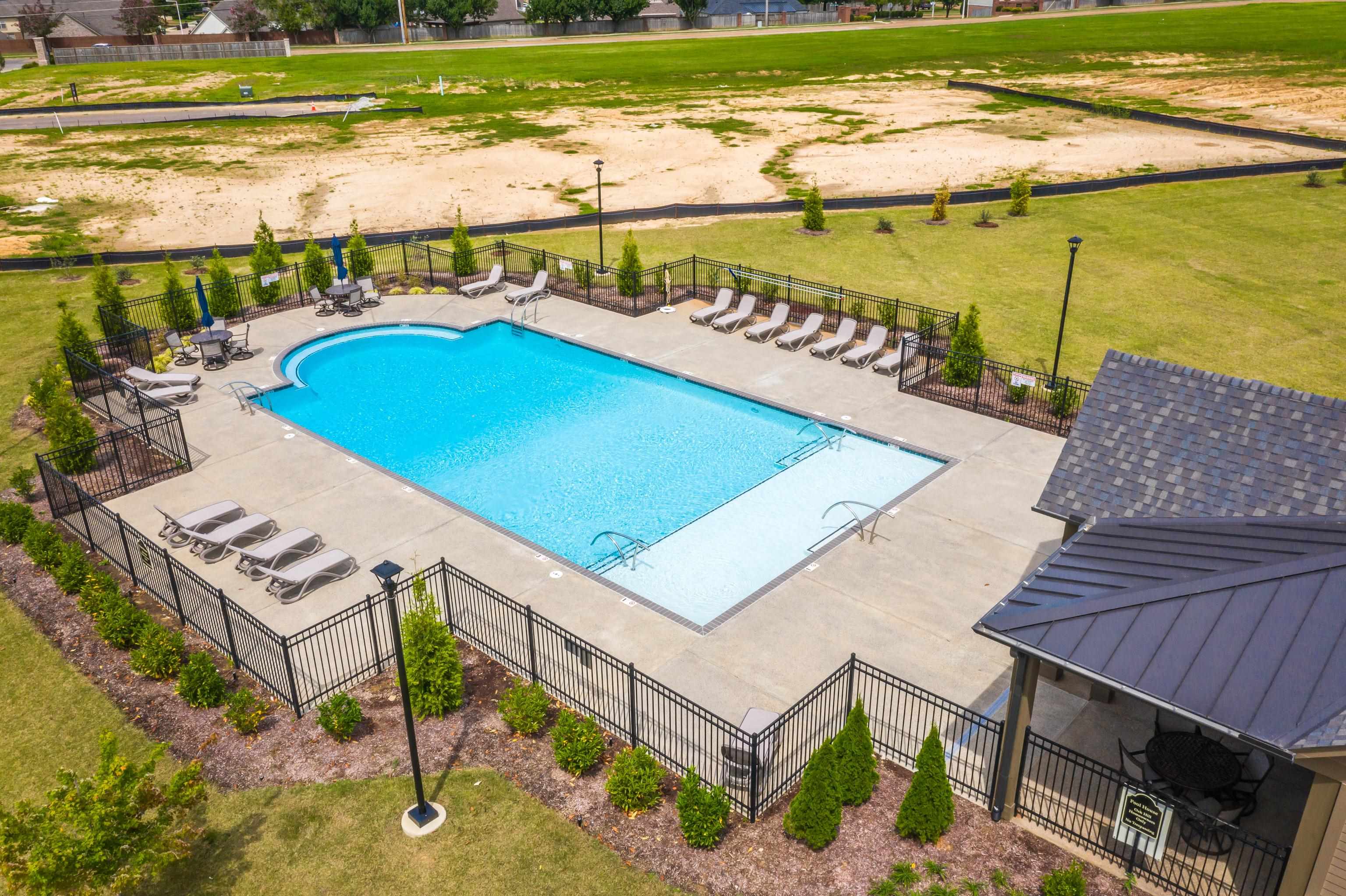 284 Keisie Lane Collierville, TN 38017 - Photo 28 of 34 Fenced community pool with expansive concrete decking, integrated lounge areas, and a covered pavilion featuring a metal roof