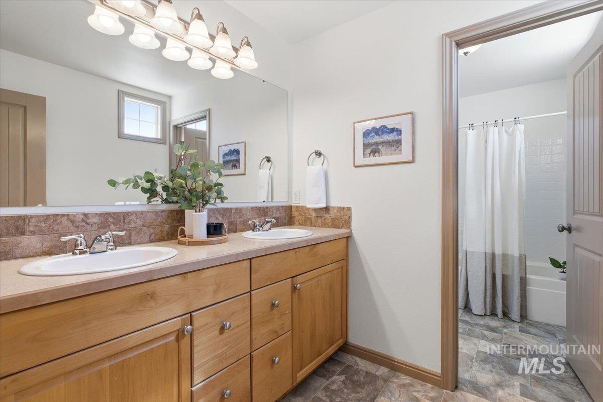 1183 North Buffalo Way Middleton, ID 83644 - Photo 29 of 47 Dual undermount sinks set into a light-toned countertop, complemented by a tiled backsplash
