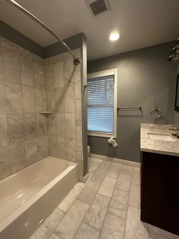 a bathroom with a bathtub and a sink