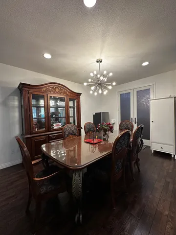 a kitchen with a refrigerator and a stove top open