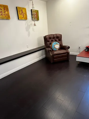 an empty room with wooden floor and window