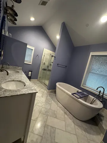 a bathroom with a granite countertop sink a toilet and mirror