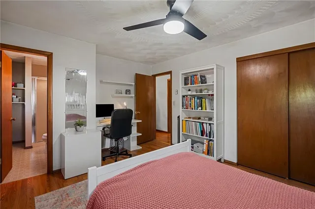 a bedroom with a bed and a book shelf