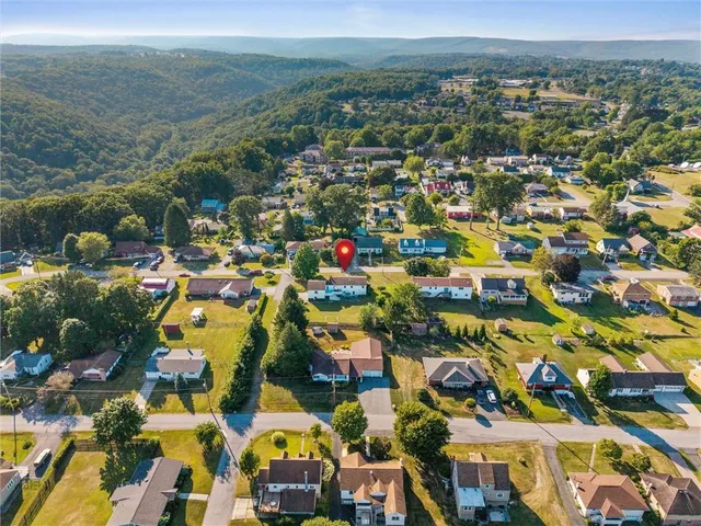 an aerial view of residential houses with outdoor space