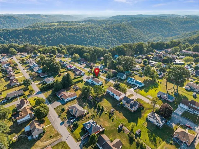 an aerial view of residential houses with outdoor space