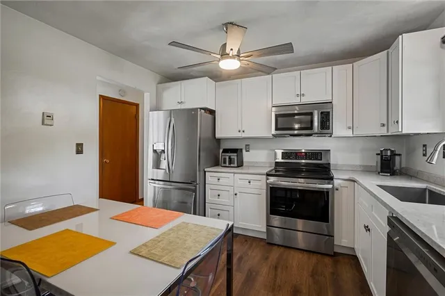 a kitchen with a stove a refrigerator and a sink