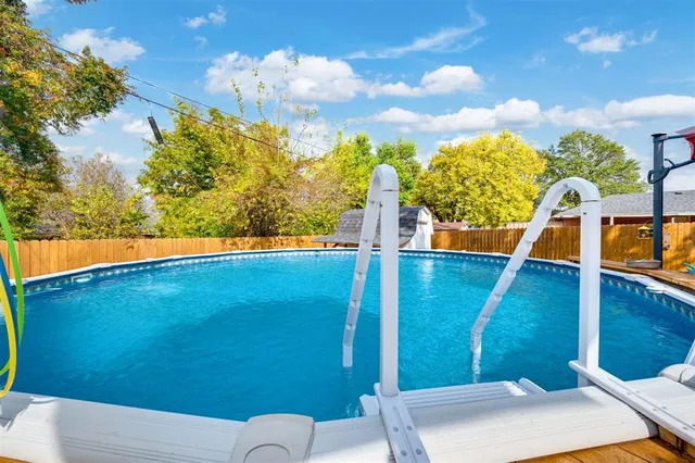 a view of a backyard with swimming pool
