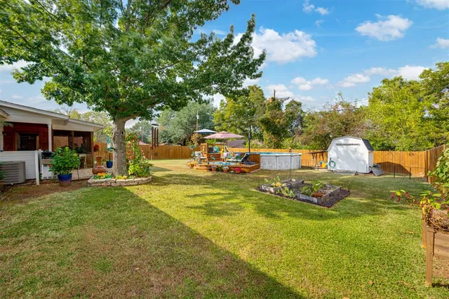 a view of a swimming pool with an outdoor seating and a yard