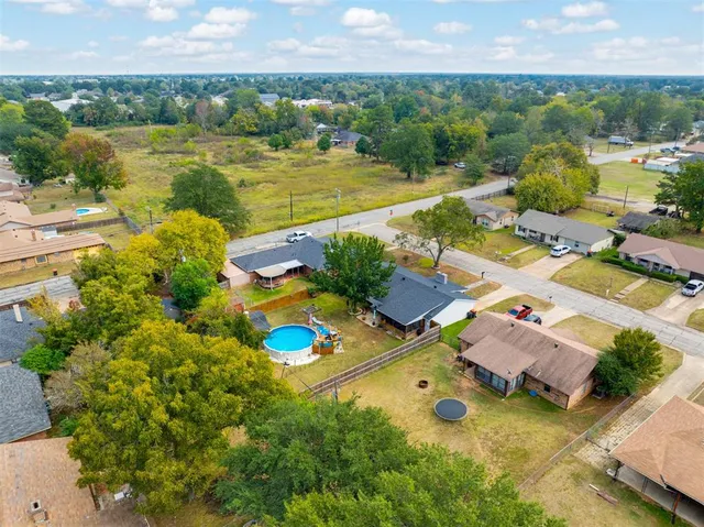 an aerial view of residential houses with outdoor space and river