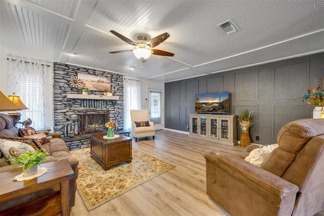 a living room with fireplace furniture and a flat screen tv