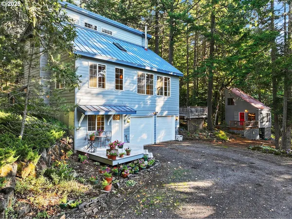 a view of a house with a yard balcony and furniture