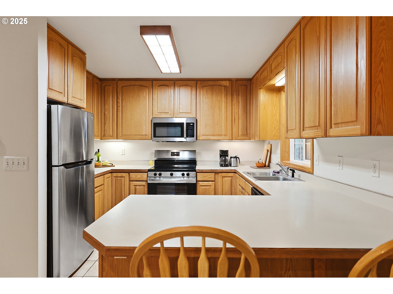 80 Echo Glen Road White Salmon, WA 98672 - Photo 11 of 48 a kitchen with stainless steel appliances granite countertop a refrigerator a sink a stove with white cabinets