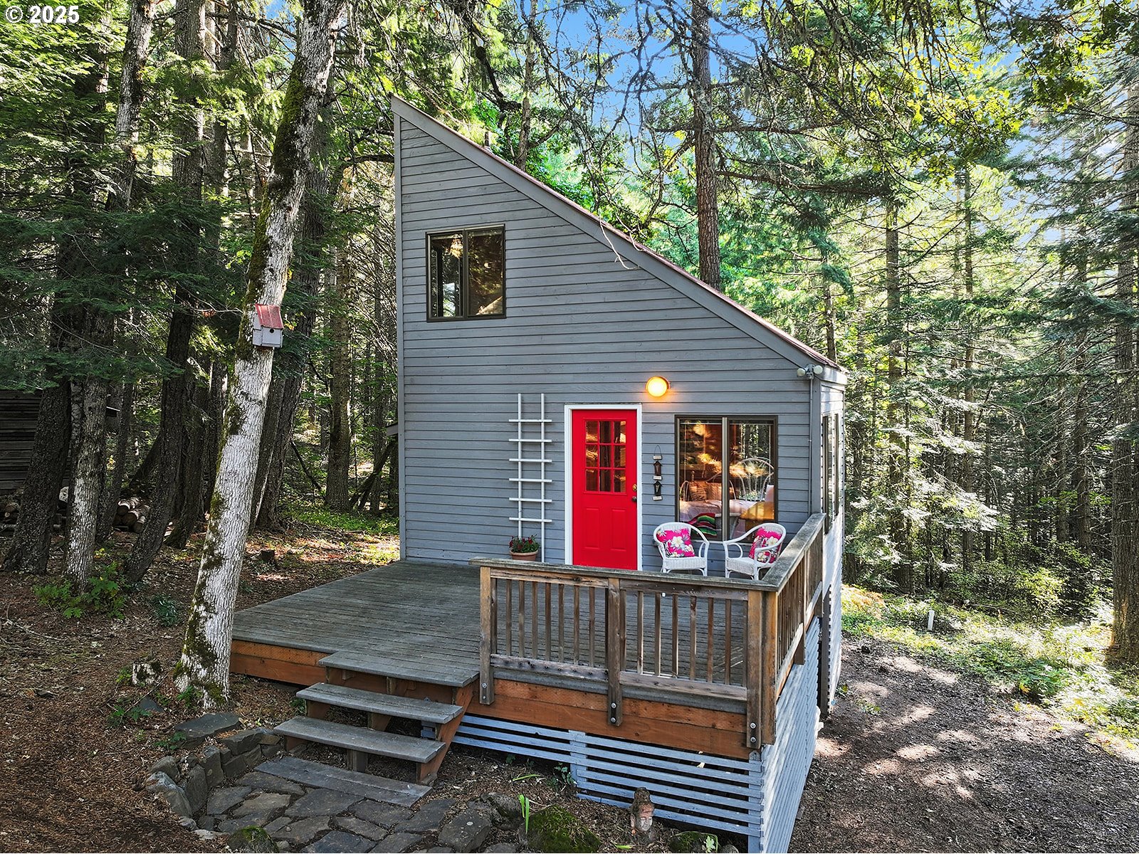 80 Echo Glen Road White Salmon, WA 98672 - Photo 34 of 48 a view of a house with a wooden bench and a tree