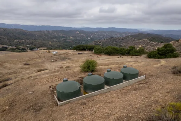 a view of a backyard of a house with mountain view