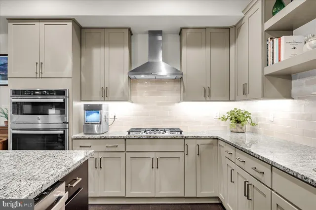 a open kitchen with a center island and stainless steel appliances