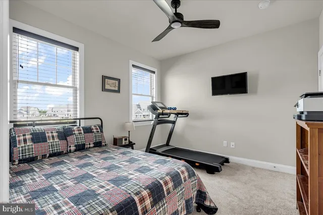 a spacious bedroom with a bed and a television