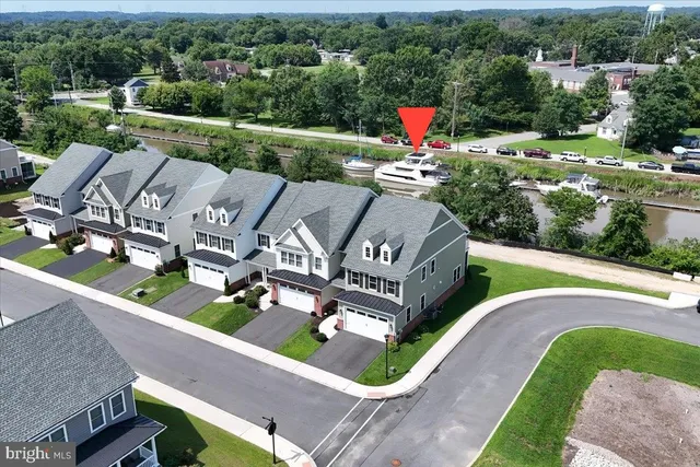an aerial view of a house with a garden and lake view