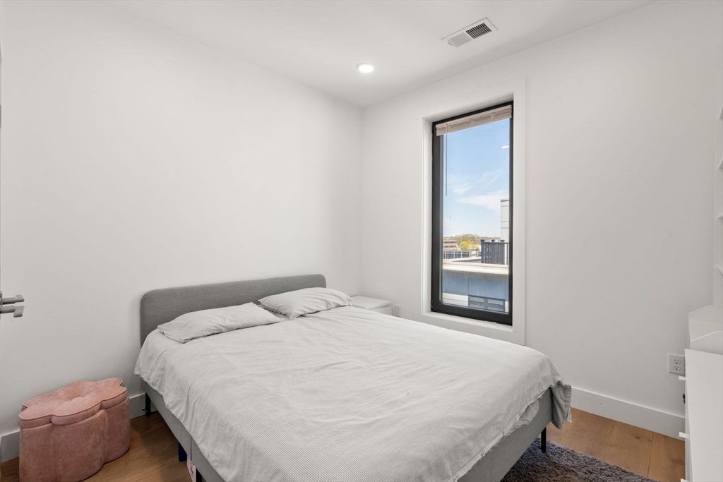 30 Penniman Road, Unit 506 Boston, MA 02134 - Photo 13 of 25 a bedroom with a bed and a window