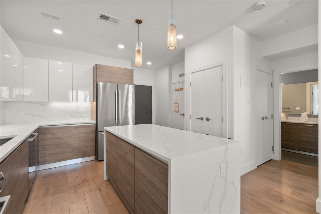 30 Penniman Road, Unit 506 Boston, MA 02134 - Photo 4 of 25 a large kitchen with a sink and refrigerator