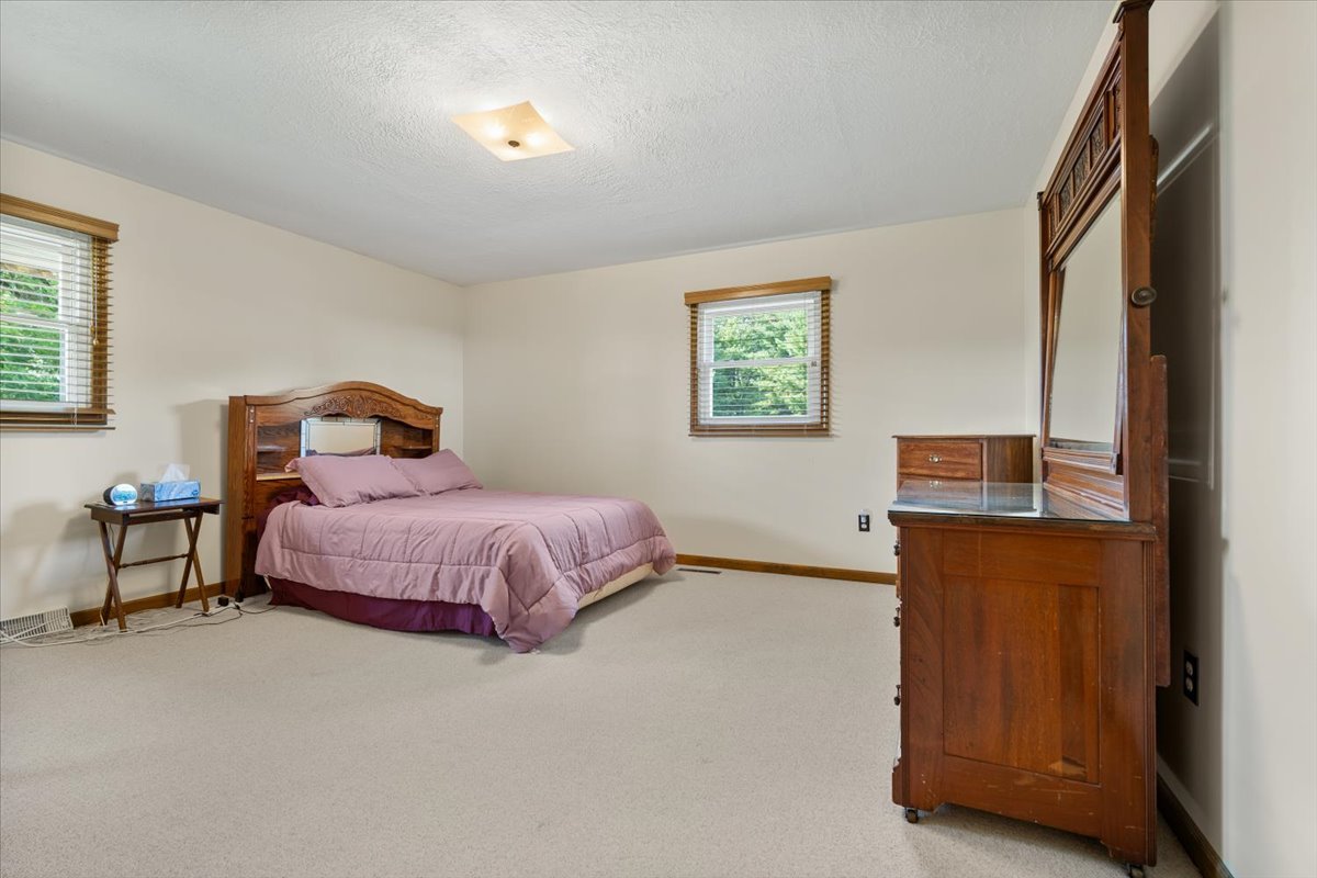 13310 Tango Road Bloomington, IL 61705 - Photo 15 of 40 a bedroom with a bed and wooden floor