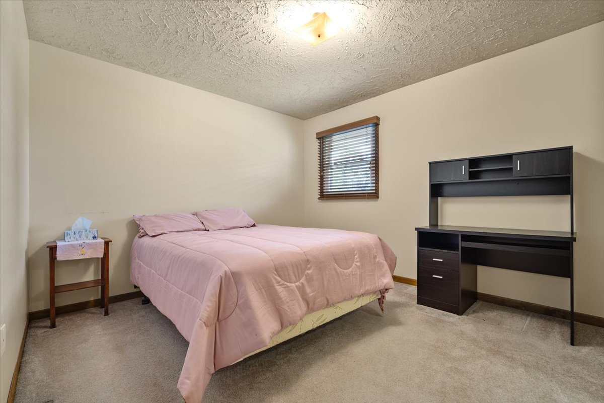 13310 Tango Road Bloomington, IL 61705 - Photo 18 of 40 a bedroom with a bed and window