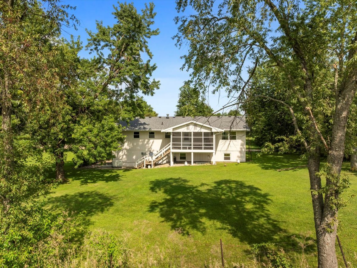 13310 Tango Road Bloomington, IL 61705 - Photo 31 of 40 a view of a house with a big yard and large trees