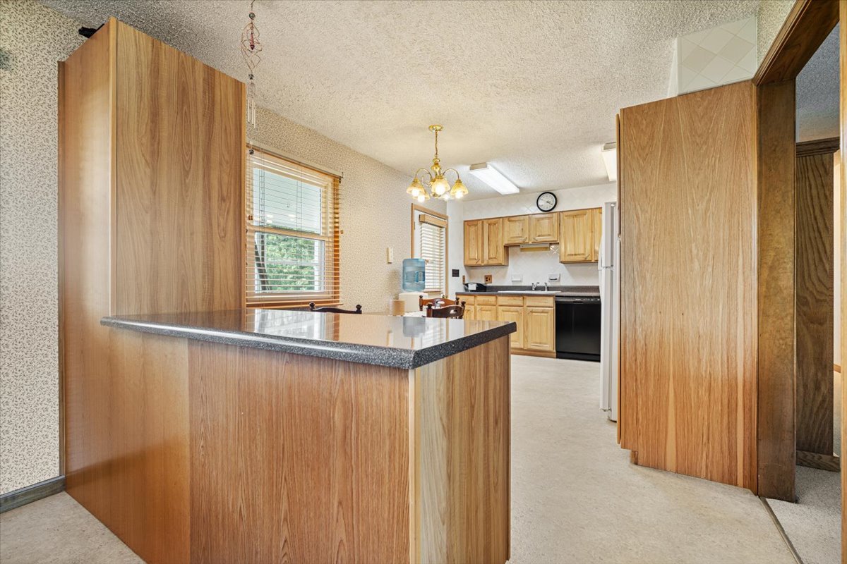 13310 Tango Road Bloomington, IL 61705 - Photo 6 of 40 a kitchen with kitchen island granite countertop wooden cabinets and sink