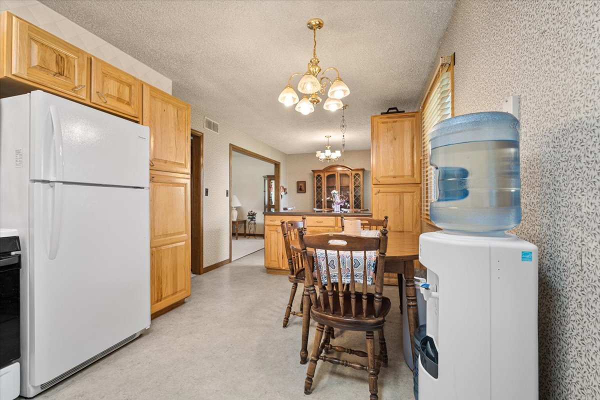 13310 Tango Road Bloomington, IL 61705 - Photo 9 of 40 a view of a dining room with furniture and a chandelier
