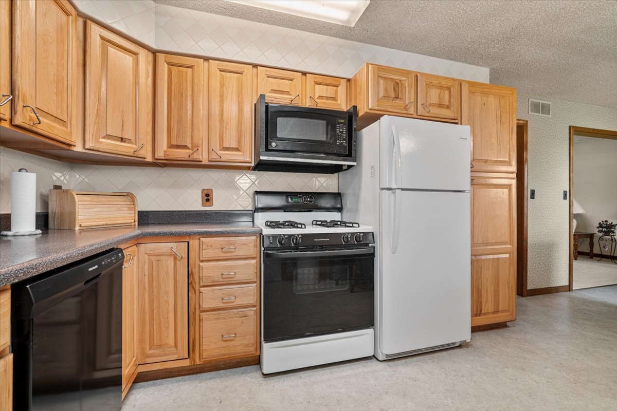 13310 Tango Road Bloomington, IL 61705 - Photo 10 of 40 a kitchen with granite countertop white cabinets and stainless steel appliances
